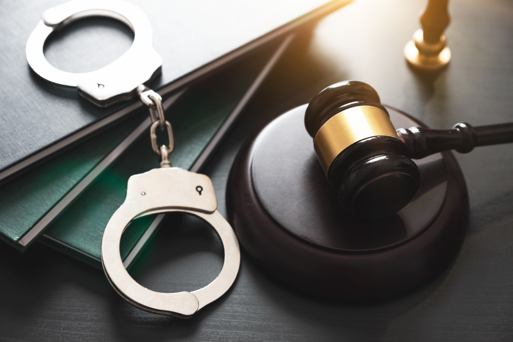 criminal defense handcuffs and gavel difference between Title IX and criminal charges